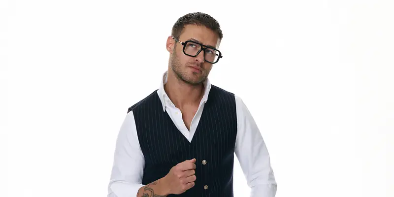 Dawid Krynicki in a pinstripe waistcoat and white shirt