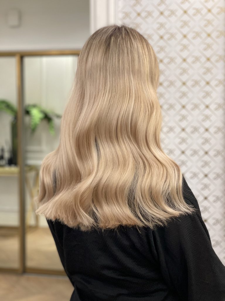 Honey blonde with soft shoulder-length waves