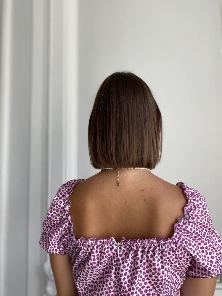 Neatly cut brown bob, seen from behind